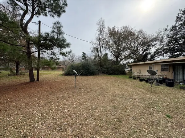 a view of a house with a yard and sitting area