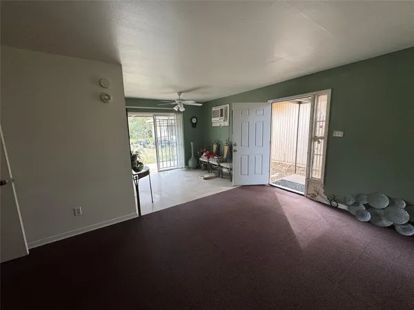 a view of a room with furniture and a window
