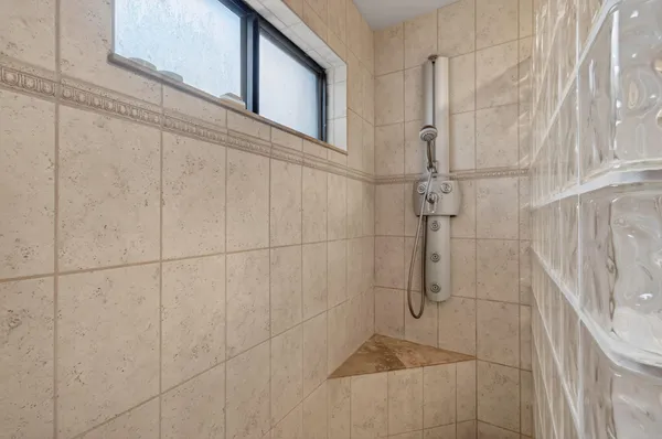 an aerial view of residential houses with outdoor space and trees