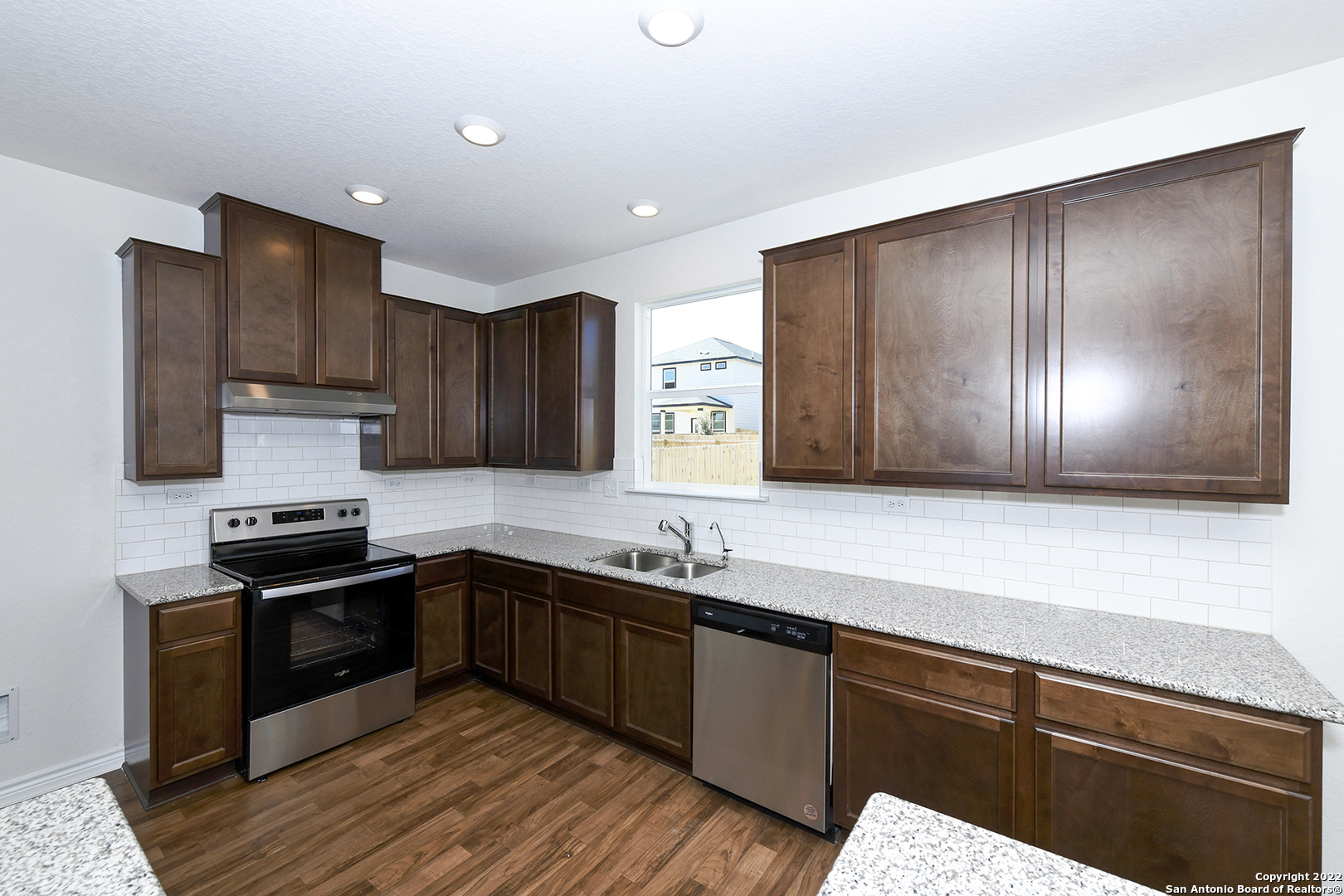 6511 Runaway Row Converse, TX 78109 - Photo 13 of 42 a kitchen with wooden cabinets and a sink