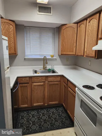 a kitchen with a sink cabinets and appliances