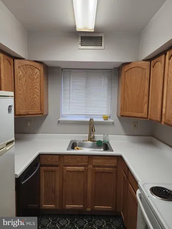 a kitchen with sink and cabinets