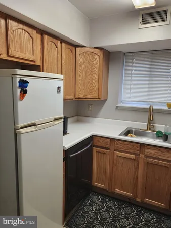 a kitchen with stainless steel appliances granite countertop a refrigerator sink and cabinets