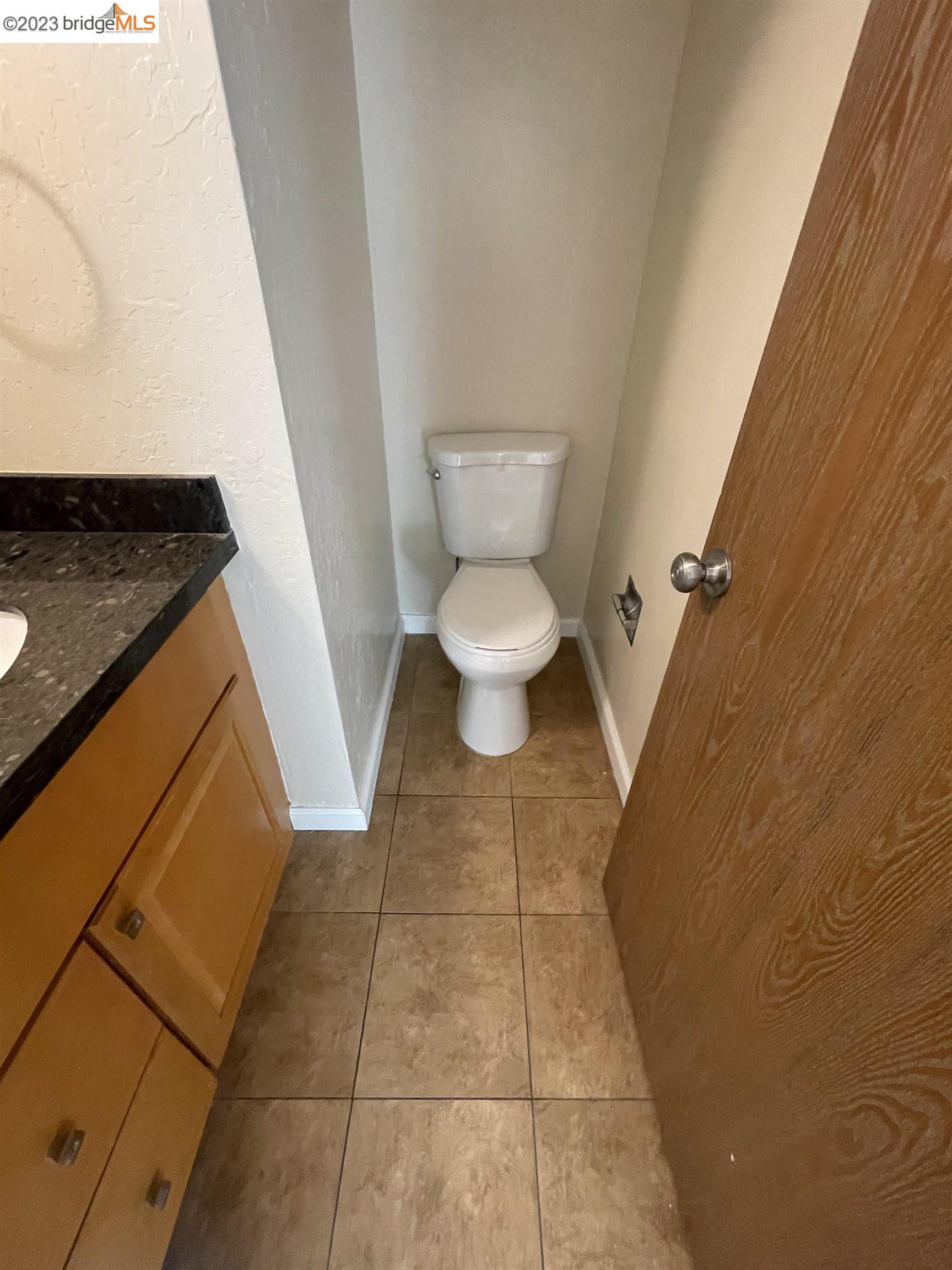 3901 Clayton Road, Unit 57 Concord, CA 94521 - Photo 16 of 40 a bathroom with a granite countertop toilet and a sink
