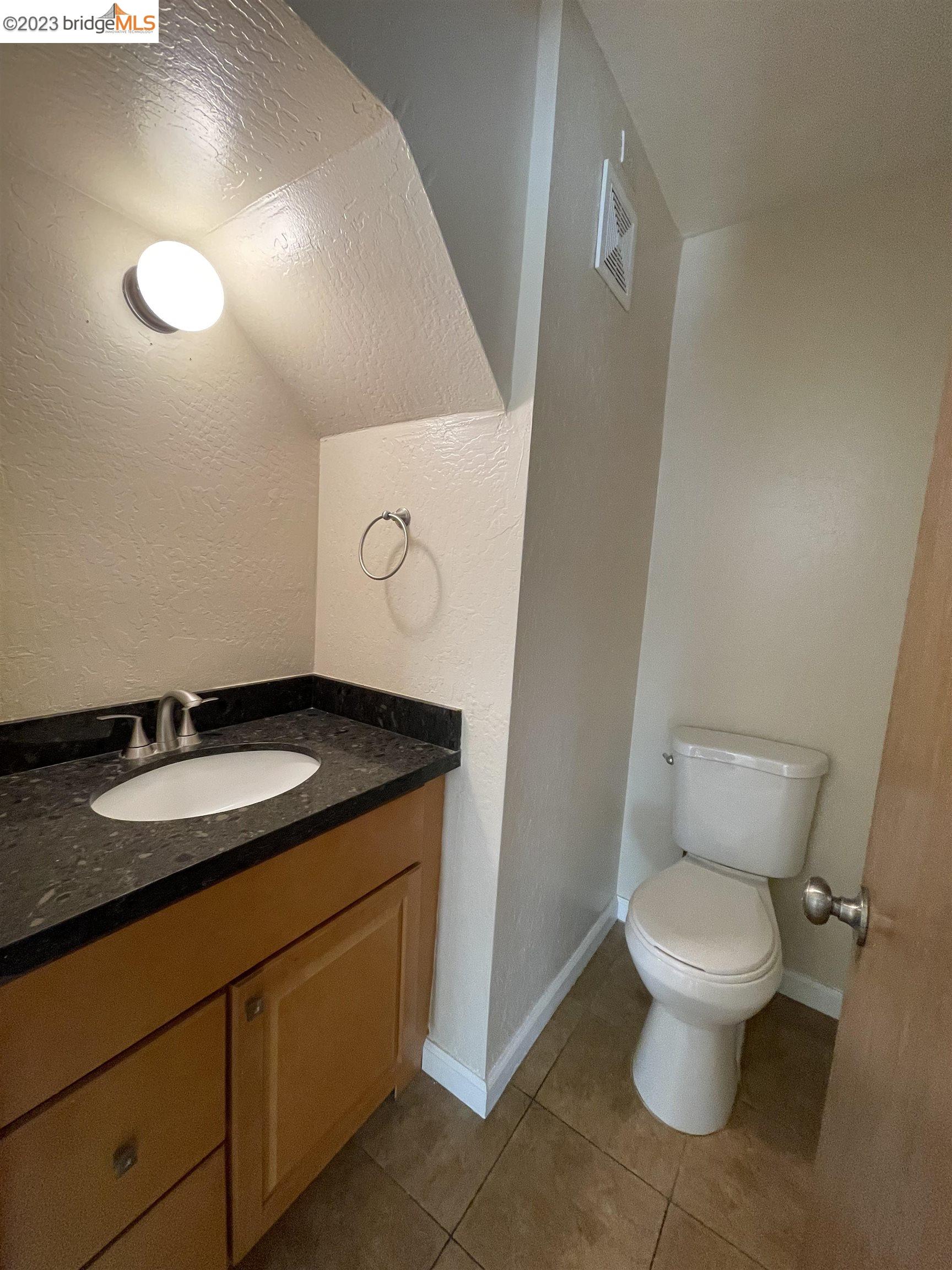 3901 Clayton Road, Unit 57 Concord, CA 94521 - Photo 18 of 40 a bathroom with a granite countertop toilet and a sink