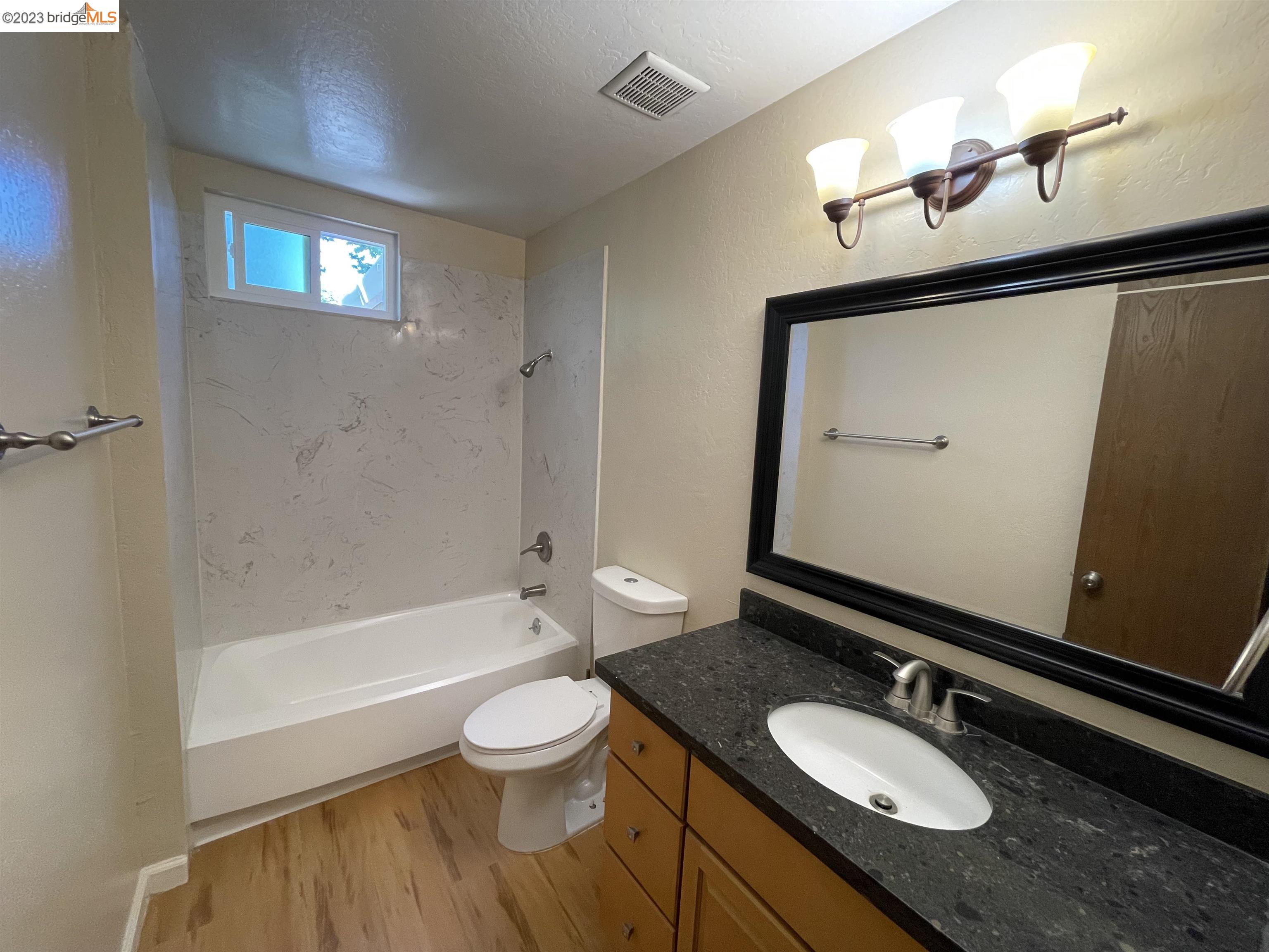 3901 Clayton Road, Unit 57 Concord, CA 94521 - Photo 31 of 40 a bathroom with a granite countertop sink toilet mirror and bathtub