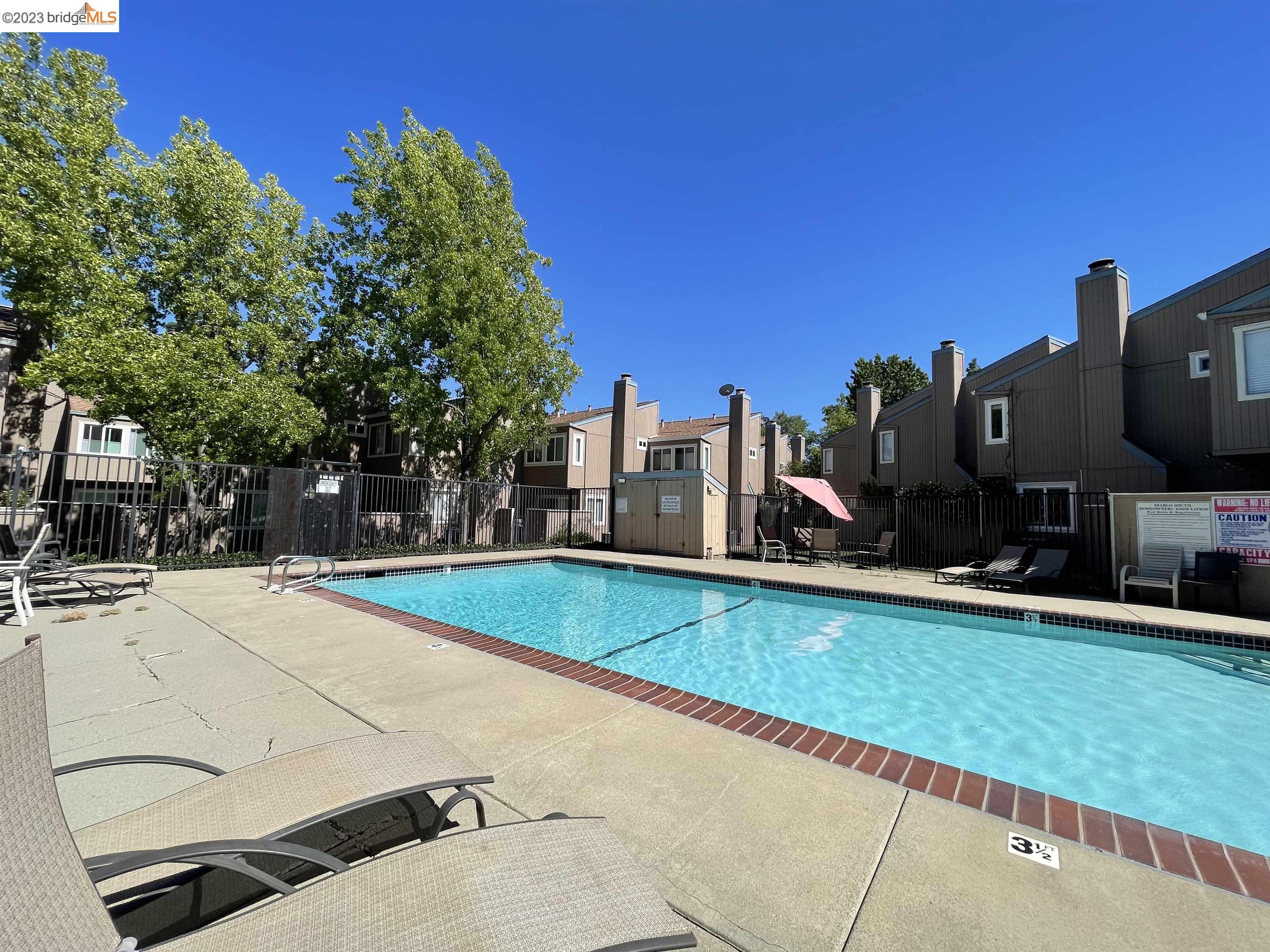 3901 Clayton Road, Unit 57 Concord, CA 94521 - Photo 37 of 40 a view of a swimming pool and a yard
