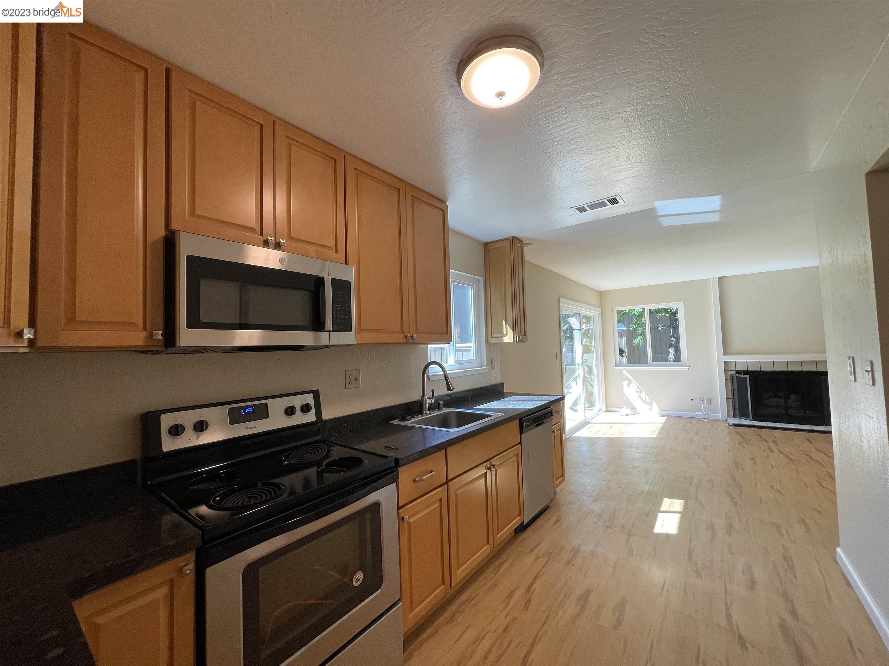 3901 Clayton Road, Unit 57 Concord, CA 94521 - Photo 8 of 40 a kitchen with stainless steel appliances a stove a microwave and cabinets