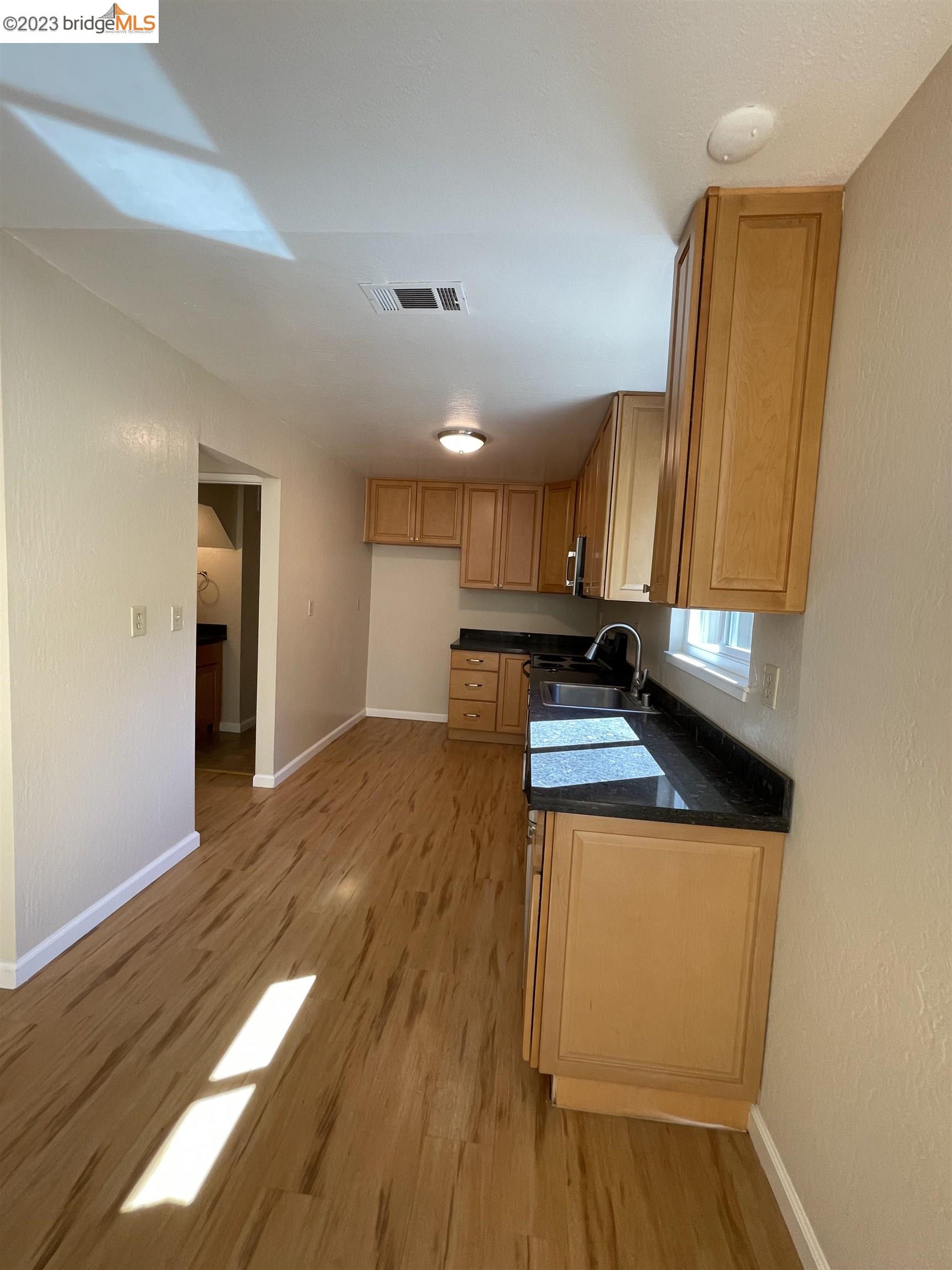 3901 Clayton Road, Unit 57 Concord, CA 94521 - Photo 10 of 40 a kitchen with a sink and wooden floor
