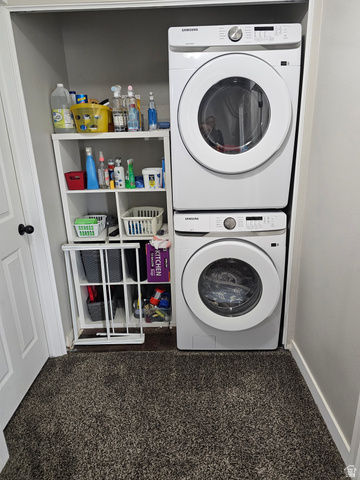 7481 Red Pine Road Eagle Mountain, UT 84005 - Photo 25 of 38 Dedicated laundry closet featuring a stacked washer and dryer unit, white shelving, and dark gray carpeting