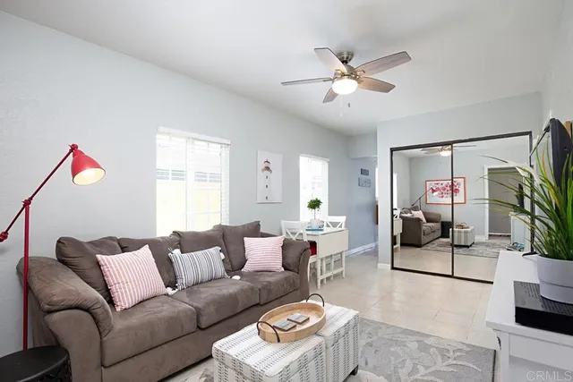 a living room with furniture and a ceiling fan