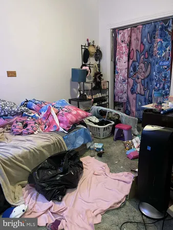 a bed room with a bed and a chair