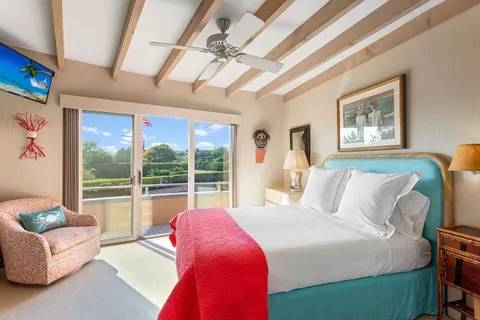 a bedroom with a bed and glass window