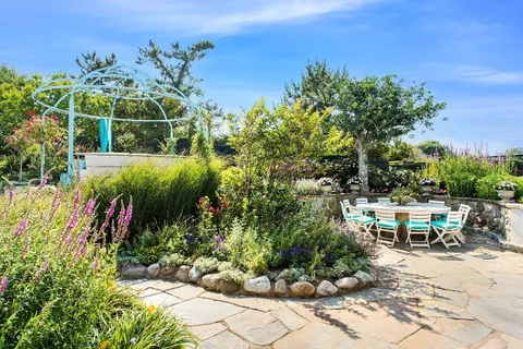 a view of a chair and tables in the garden