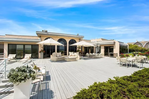 a view of a house with sitting area and garden