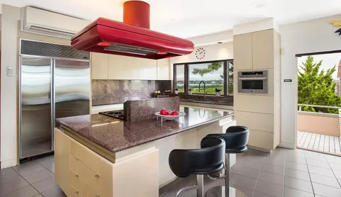 a kitchen with stainless steel appliances granite countertop a sink and a refrigerator