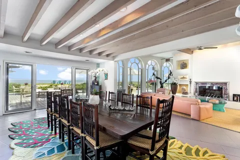 a view of a dining room with furniture large windows and wooden floor