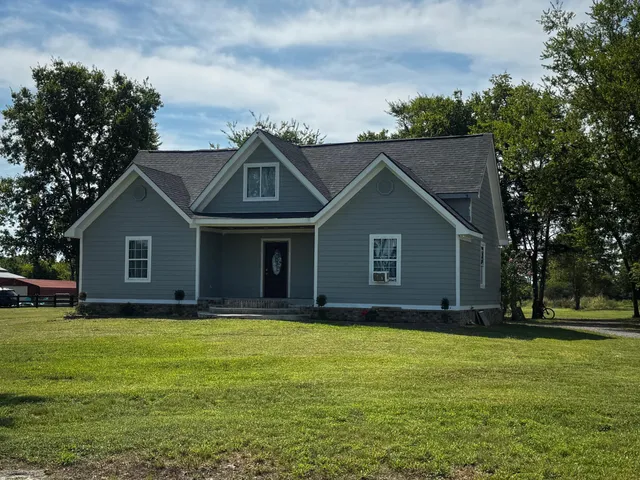 a house with huge green field in front of it