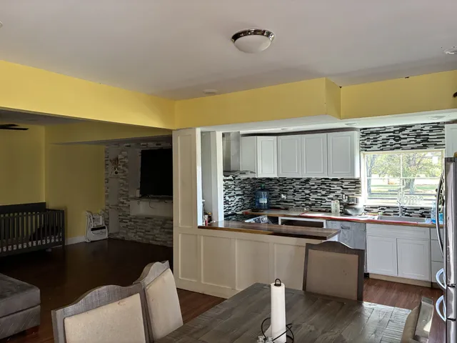 a kitchen with stainless steel appliances kitchen island granite countertop a sink and cabinets