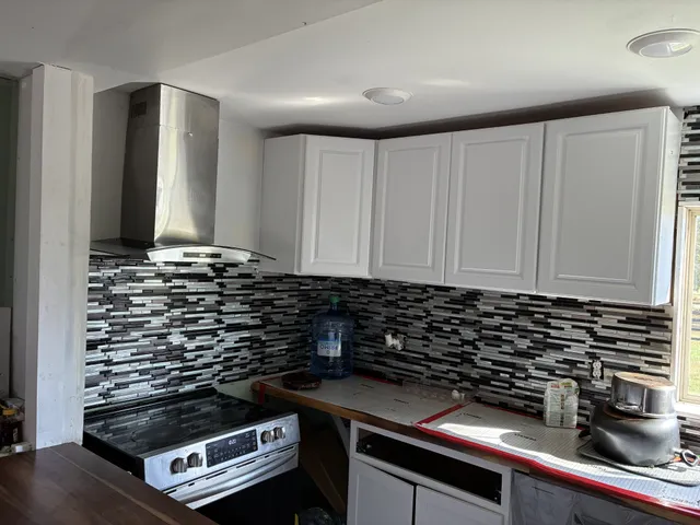 a view of a kitchen with sink and wooden floor