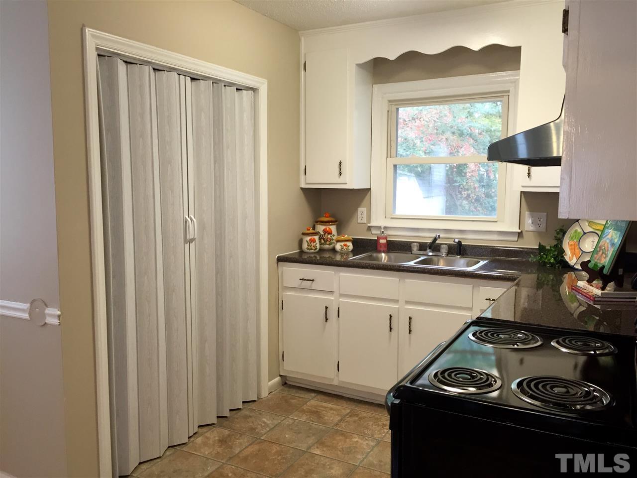 706 Chandler Road Durham, NC 27703 - Photo 11 of 24 a kitchen with a stove and a cabinet