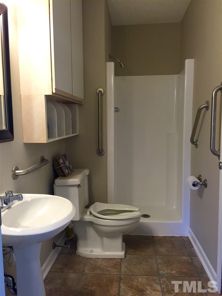 706 Chandler Road Durham, NC 27703 - Photo 16 of 24 a bathroom with a sink a toilet and shower