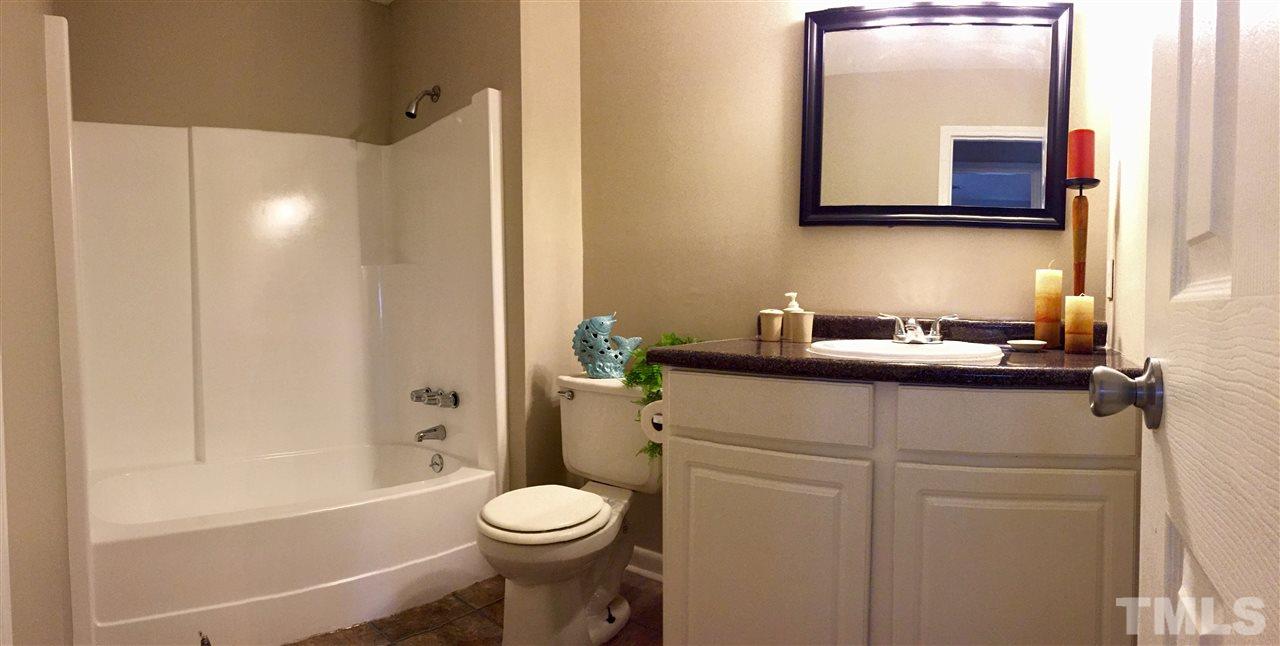 706 Chandler Road Durham, NC 27703 - Photo 19 of 24 a bathroom with a sink a toilet and shower