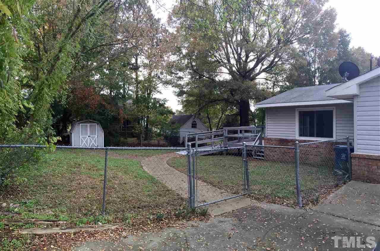 706 Chandler Road Durham, NC 27703 - Photo 20 of 24 a backyard of a house with table and chairs