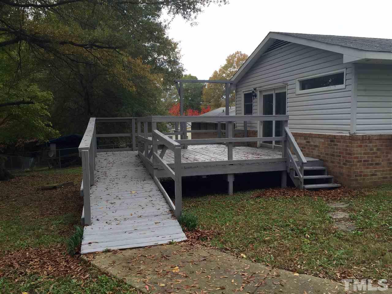 706 Chandler Road Durham, NC 27703 - Photo 23 of 24 a view of a house with wooden deck
