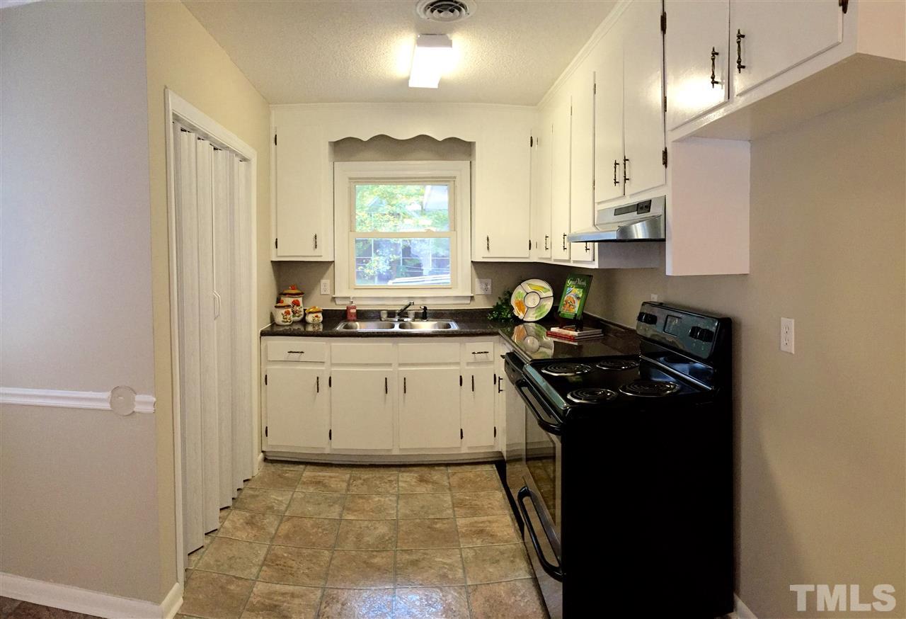 706 Chandler Road Durham, NC 27703 - Photo 9 of 24 a kitchen with a stove a sink and a refrigerator