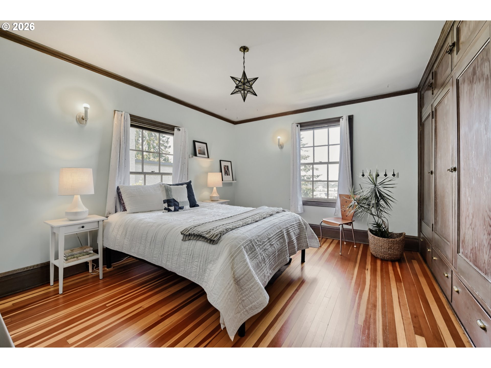 2833 Northwest Cumberland Road Portland, OR 97210 - Photo 15 of 28 a spacious bedroom with a bed and wooden floor