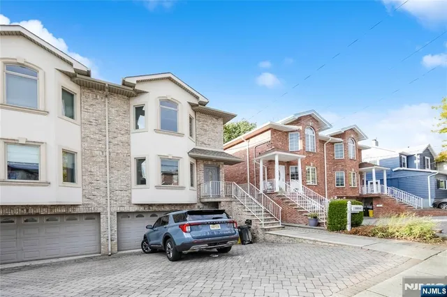 a car parked in front of a white house