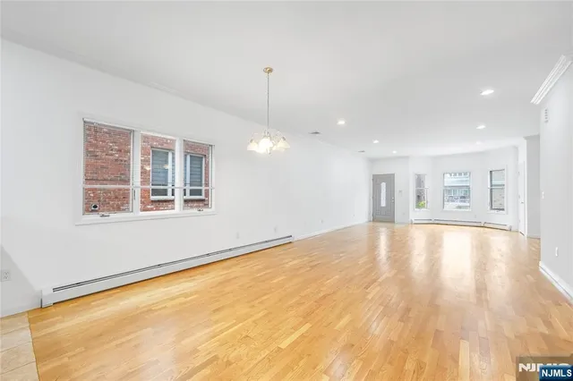 a kitchen with stainless steel appliances granite countertop a sink counter space cabinets and a large window