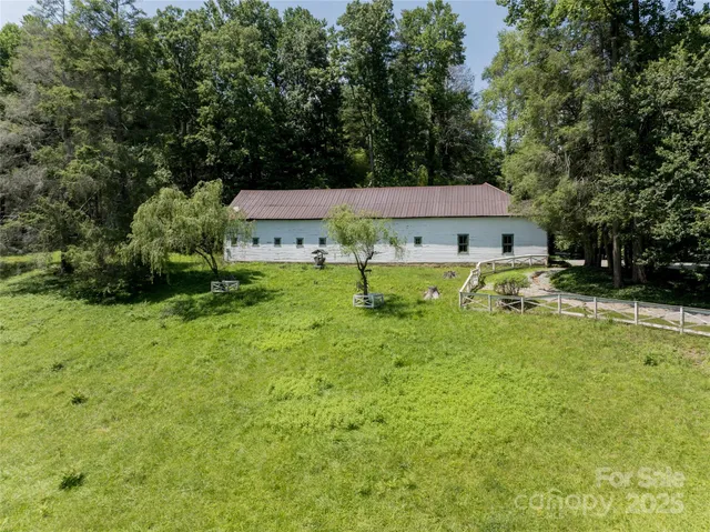 an aerial view of a house with swimming pool garden and patio