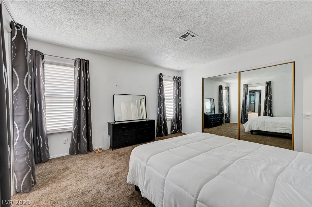 1751 East Reno Avenue, Unit 228 Las Vegas, NV 89119 - Photo 22 of 39 Plush carpeting and mirrored closet doors enhance this comfortable bedroom retreat.