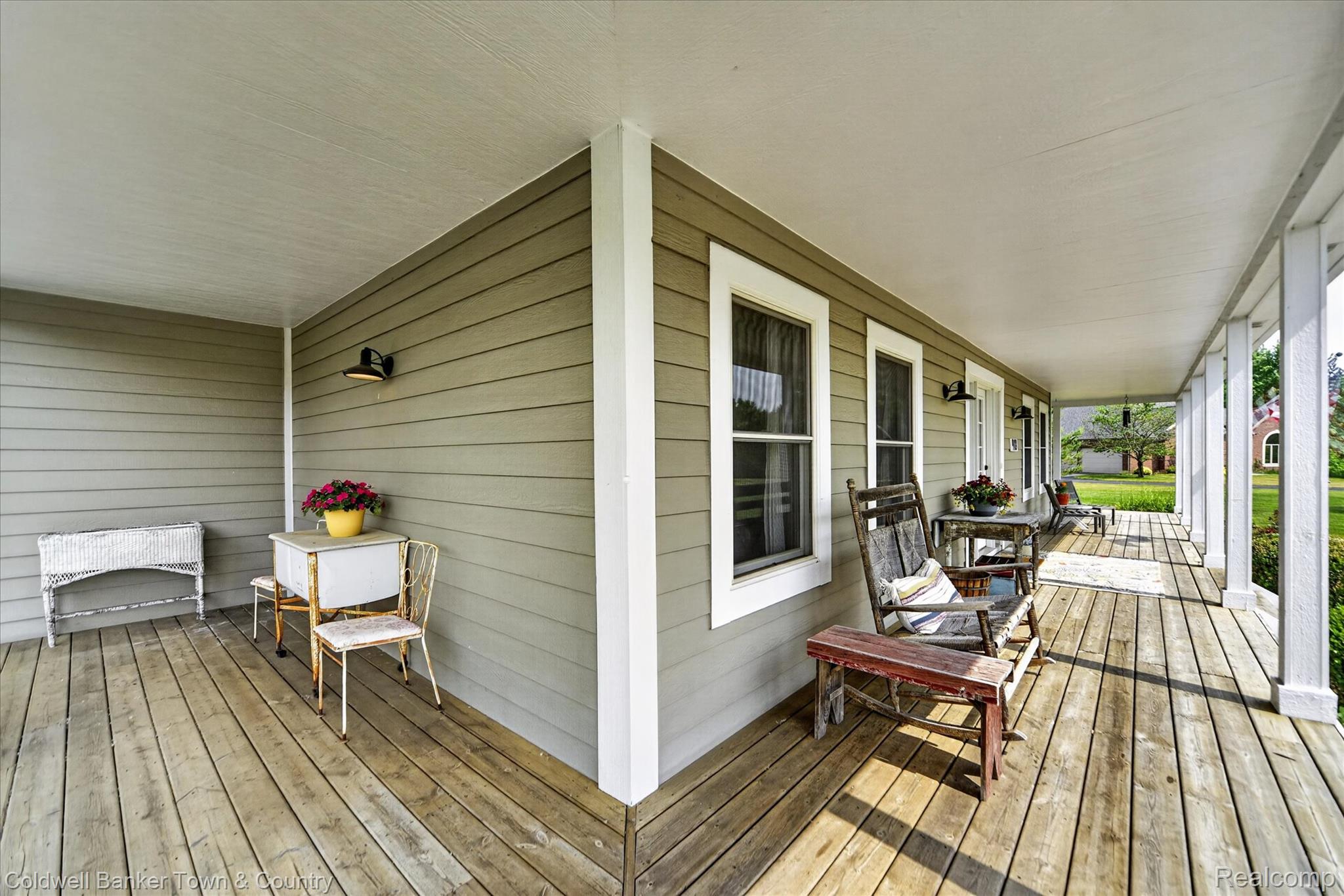 918 Gray Fox Court Howell, MI 48843 - Photo 7 of 84 Expansive covered porch featuring a wood-finish floor, white pillars, and neutral-toned siding
