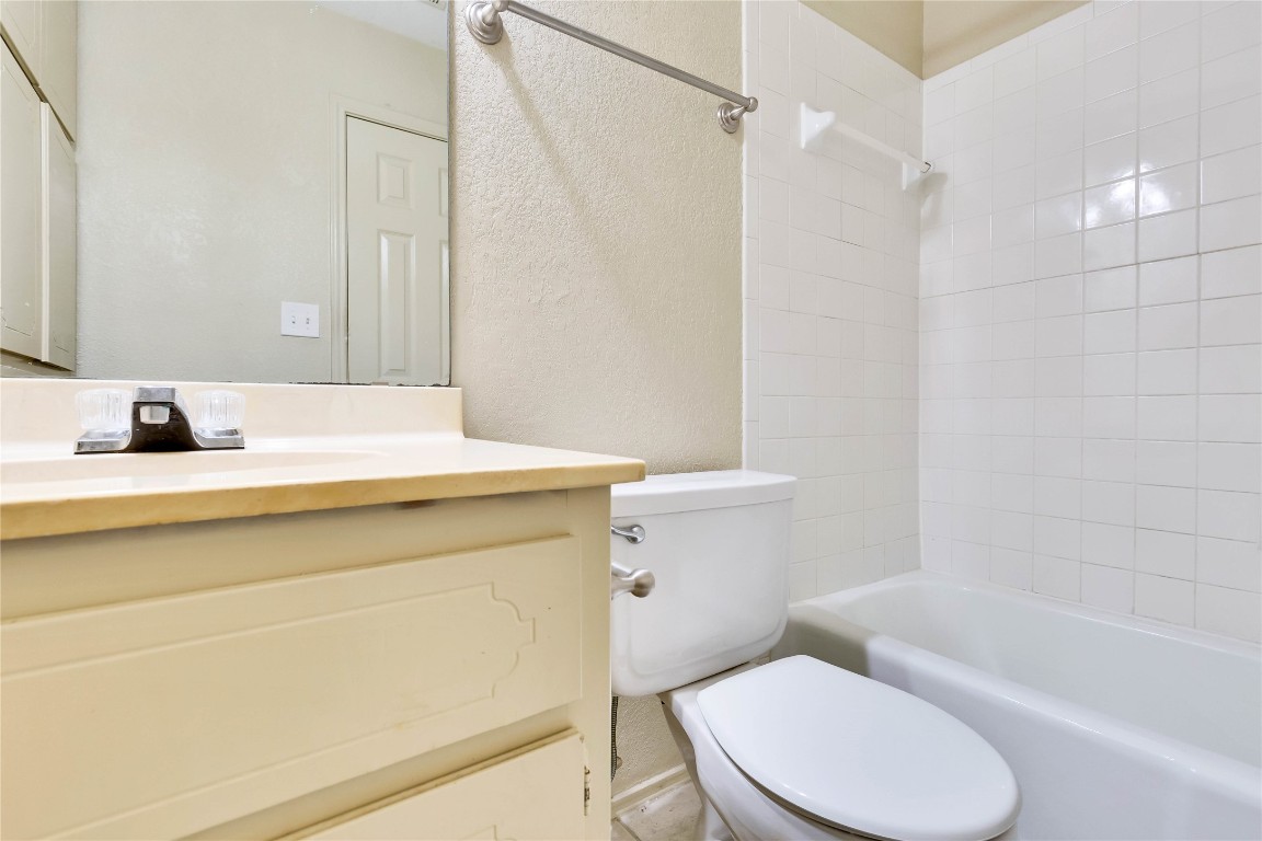 8806 Springmail Circle, Unit B Austin, TX 78729 - Photo 12 of 16 a bathroom with a sink toilet and shower