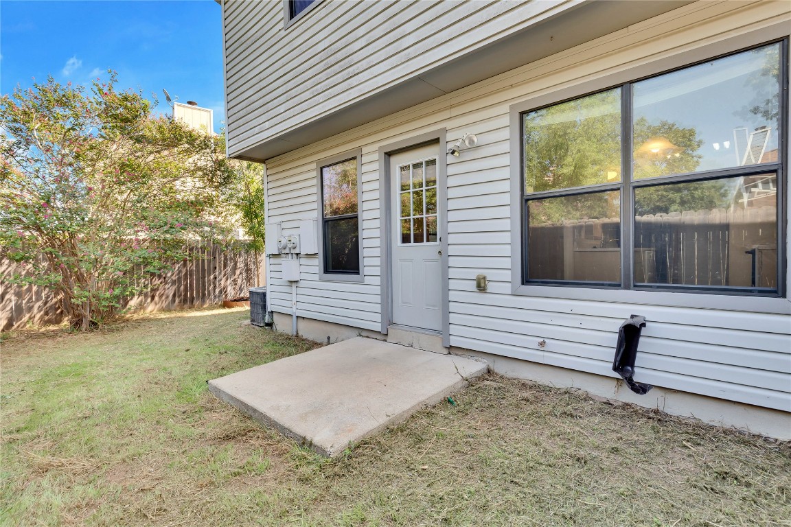 8806 Springmail Circle, Unit B Austin, TX 78729 - Photo 15 of 16 a view of a house with a yard and wooden fence
