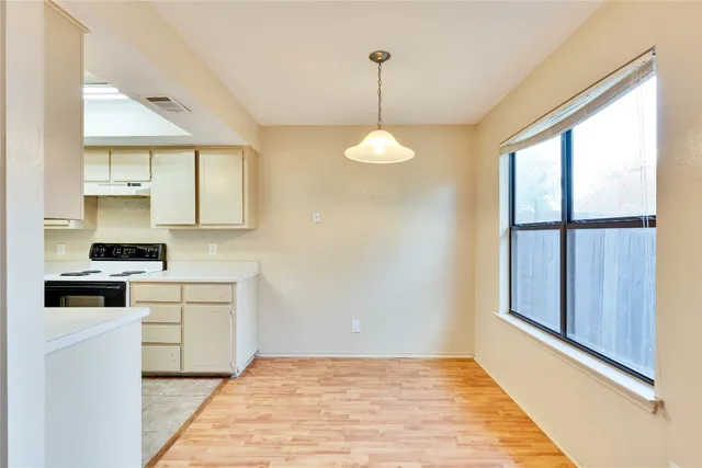 a kitchen with a stove and a wooden floors