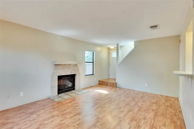 a view of an empty room with a fireplace