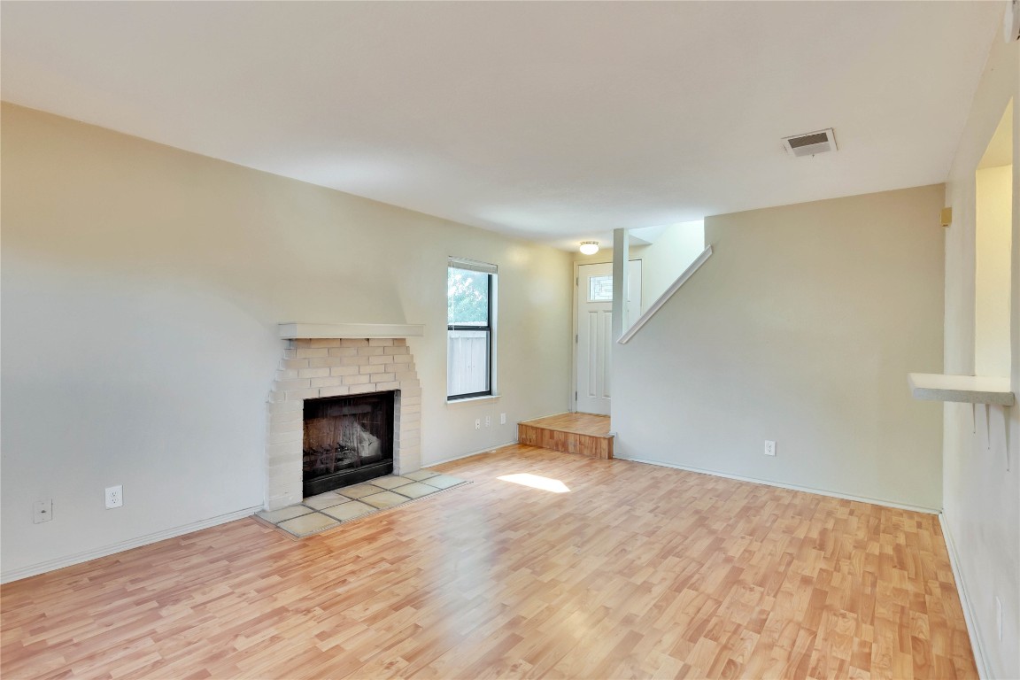 8806 Springmail Circle, Unit B Austin, TX 78729 - Photo 6 of 16 a view of an empty room with a fireplace