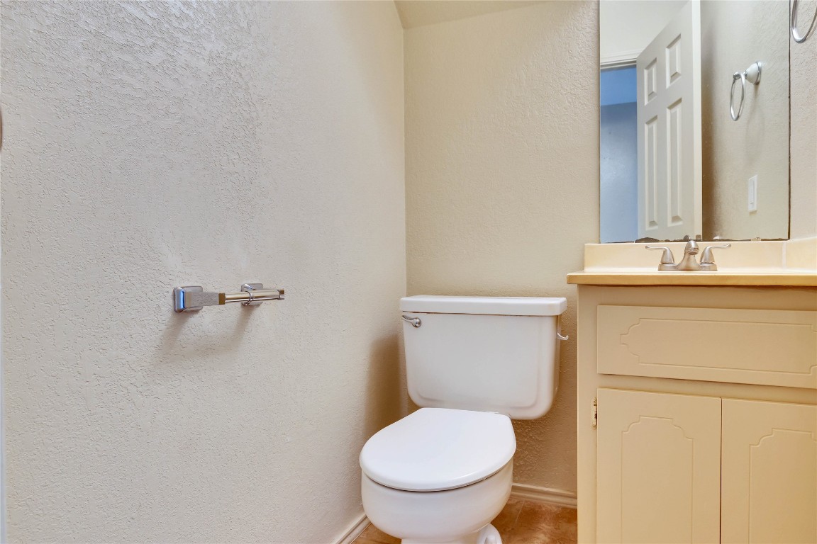8806 Springmail Circle, Unit B Austin, TX 78729 - Photo 9 of 16 a white toilet sitting next to a bathroom sink