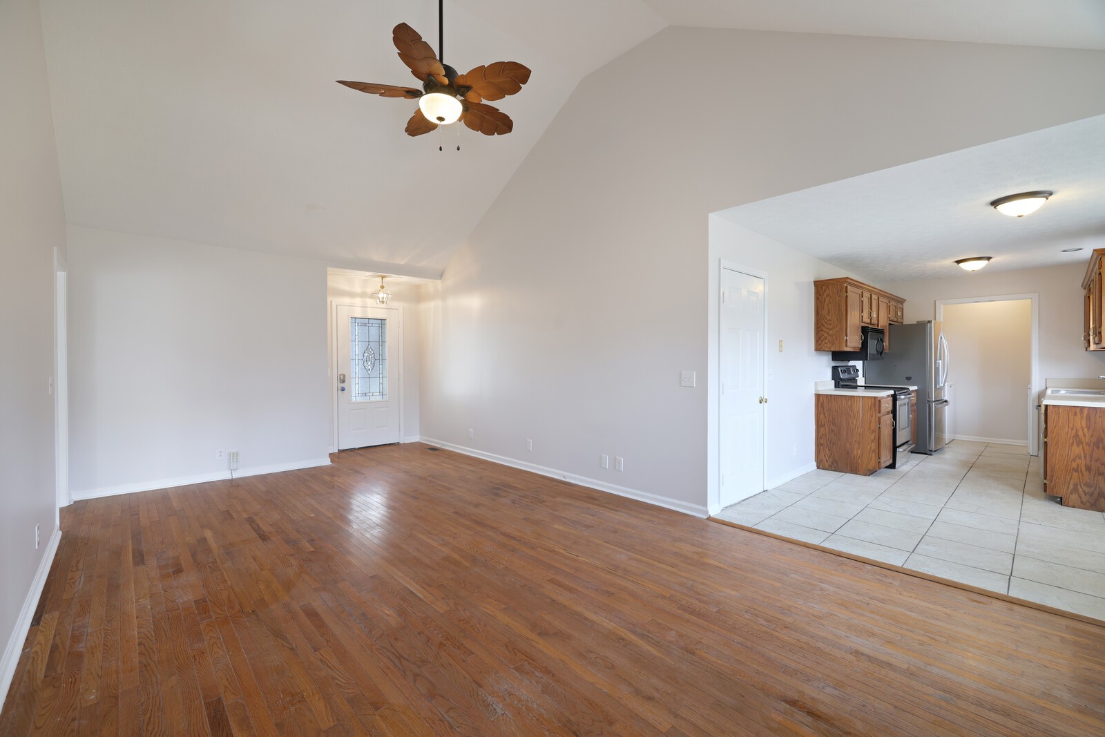 244 Green Hills Drive Springfield, TN 37172 - Photo 3 of 18 a view of a kitchen with wooden floor and a ceiling fan