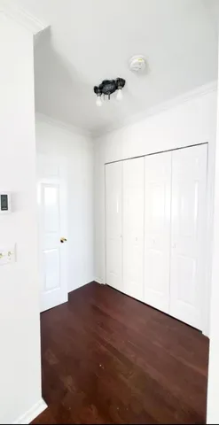 a view of a room with wooden floor