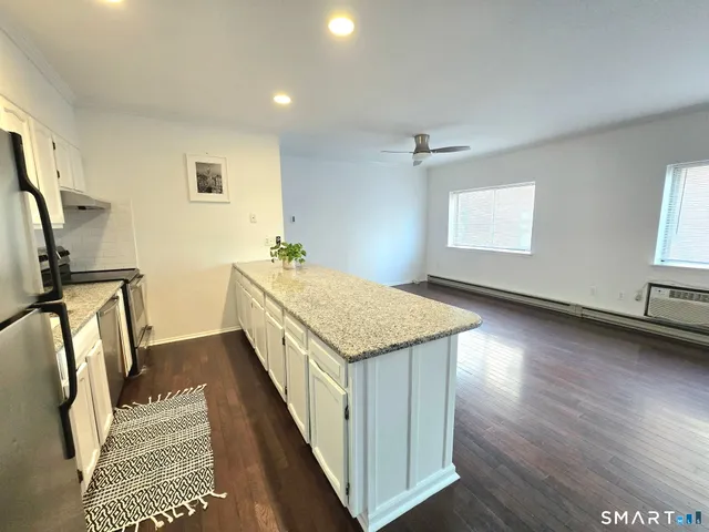 a kitchen with a sink stove and refrigerator