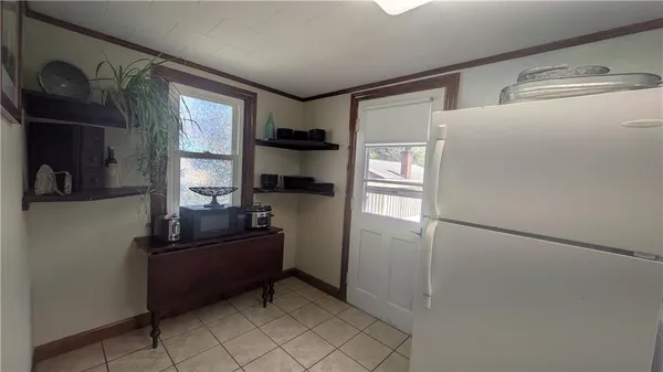 a kitchen with refrigerator and window