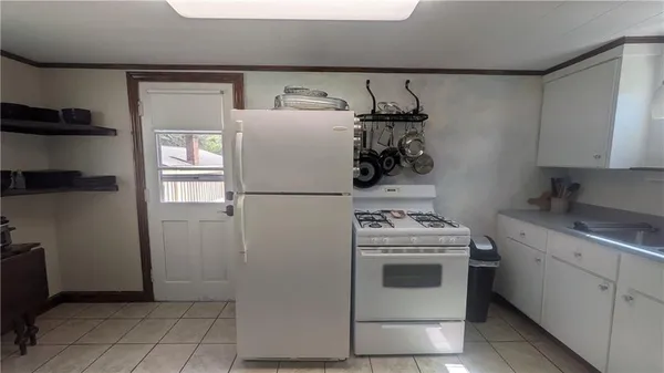 a kitchen with refrigerator and cabinets