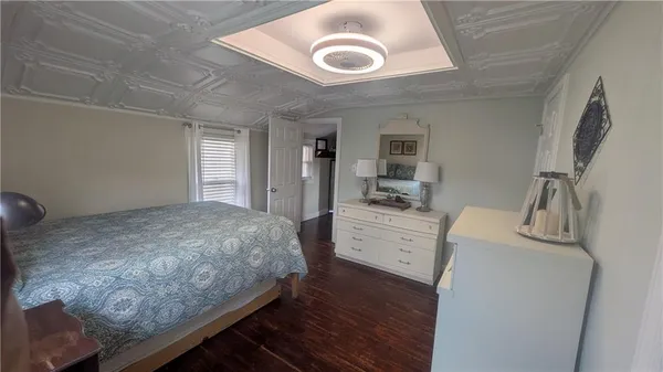 a bedroom with a bed and a dresser