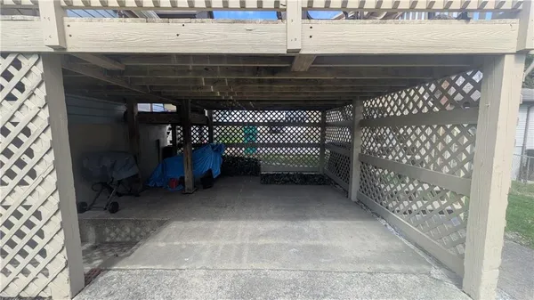 a view of water heater room with wooden floor