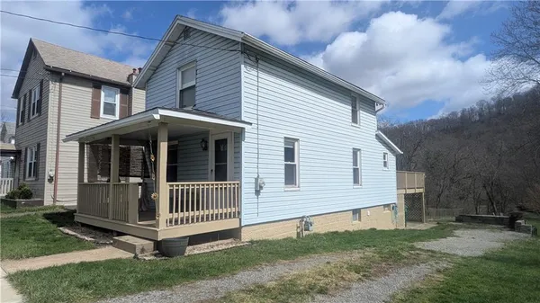 a view of backyard with deck and backyard